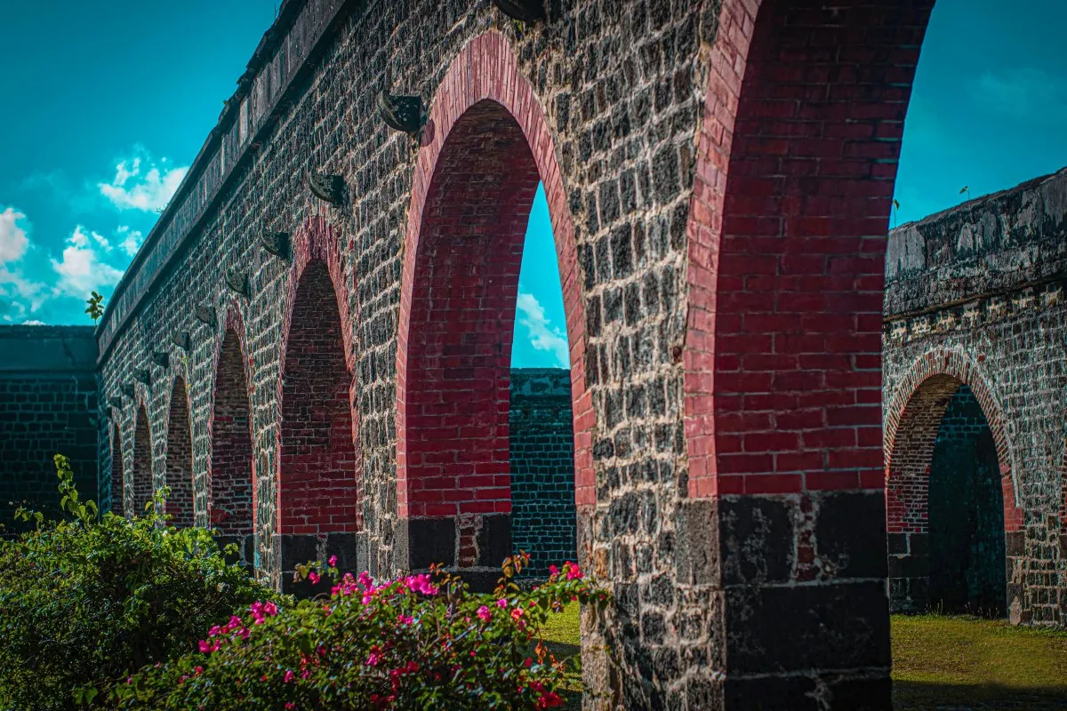 Old stone wall ruins of an abandoned sugar factory with round top entrances in Belle Mare, Mauritius