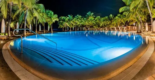 Deep HDR blueish infinity hotel pool at night