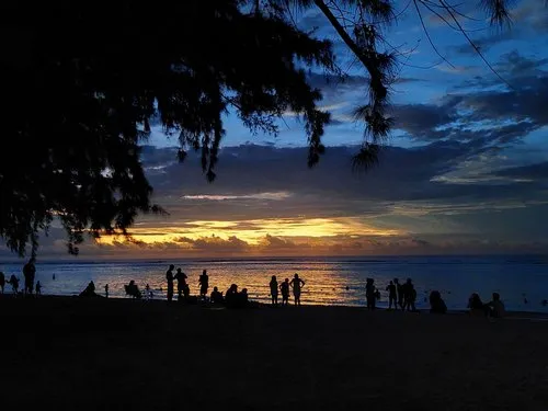 Silhouette of people at Flic en Flac after dusk