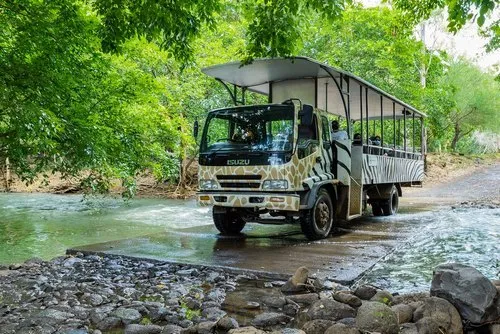 The Casela bus crossing a river