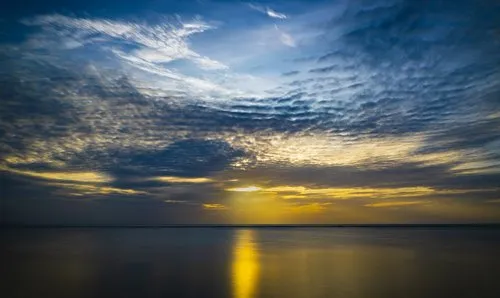Reflection of shy sunset at Albion beach