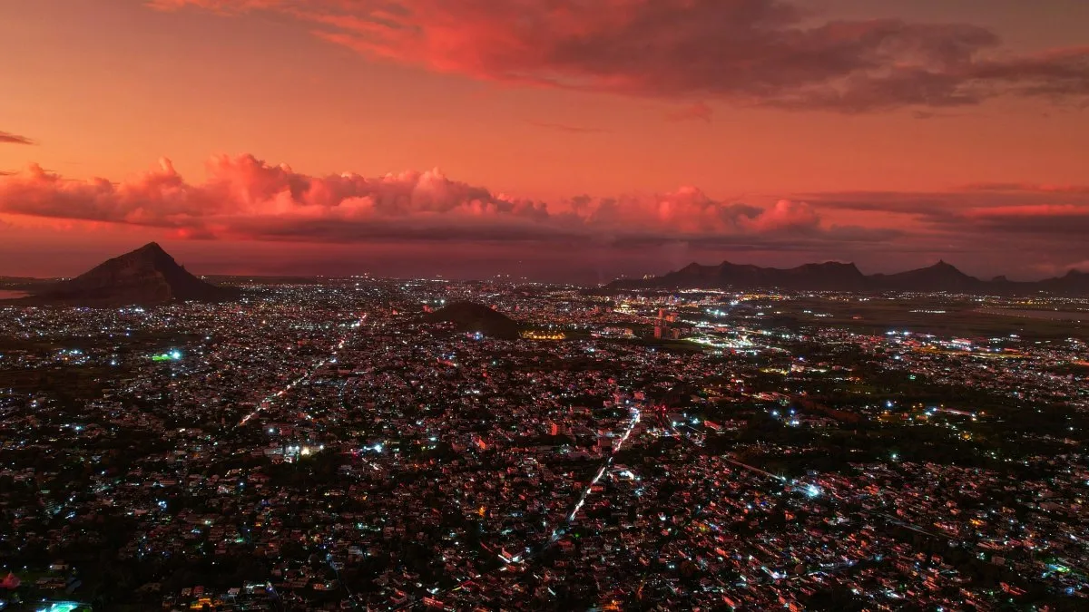 Aerial night view of illuminated Vacoas town with pink sky after cyclone in Mauritius