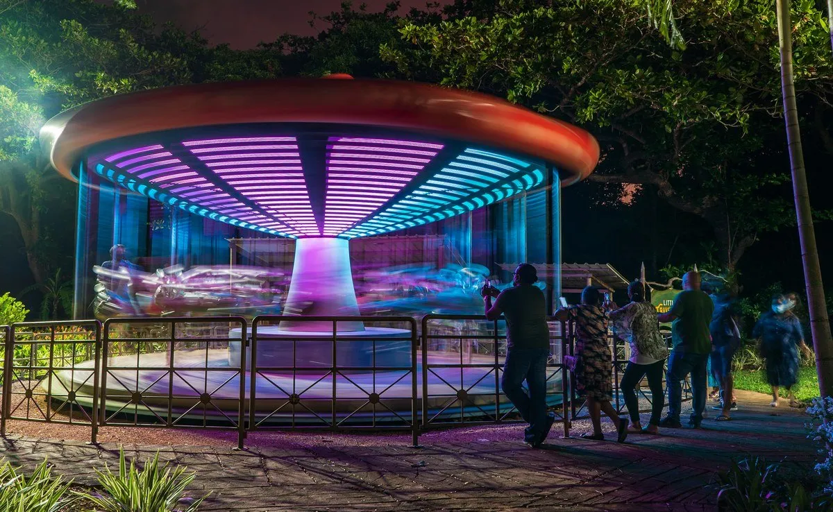 Colorful children's merry-go-round with animal figures at Casela Nature Park in Mauritius at night