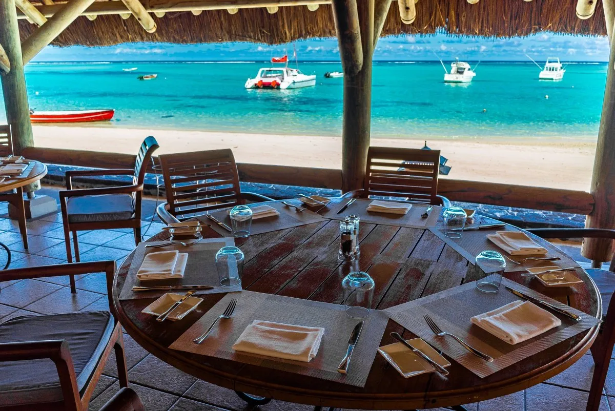 Table at Blue Marlin Restaurant overlooking calm lagoon and beach in Mauritius
