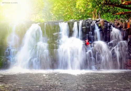 Man climbing the resplendent Rochester Falls