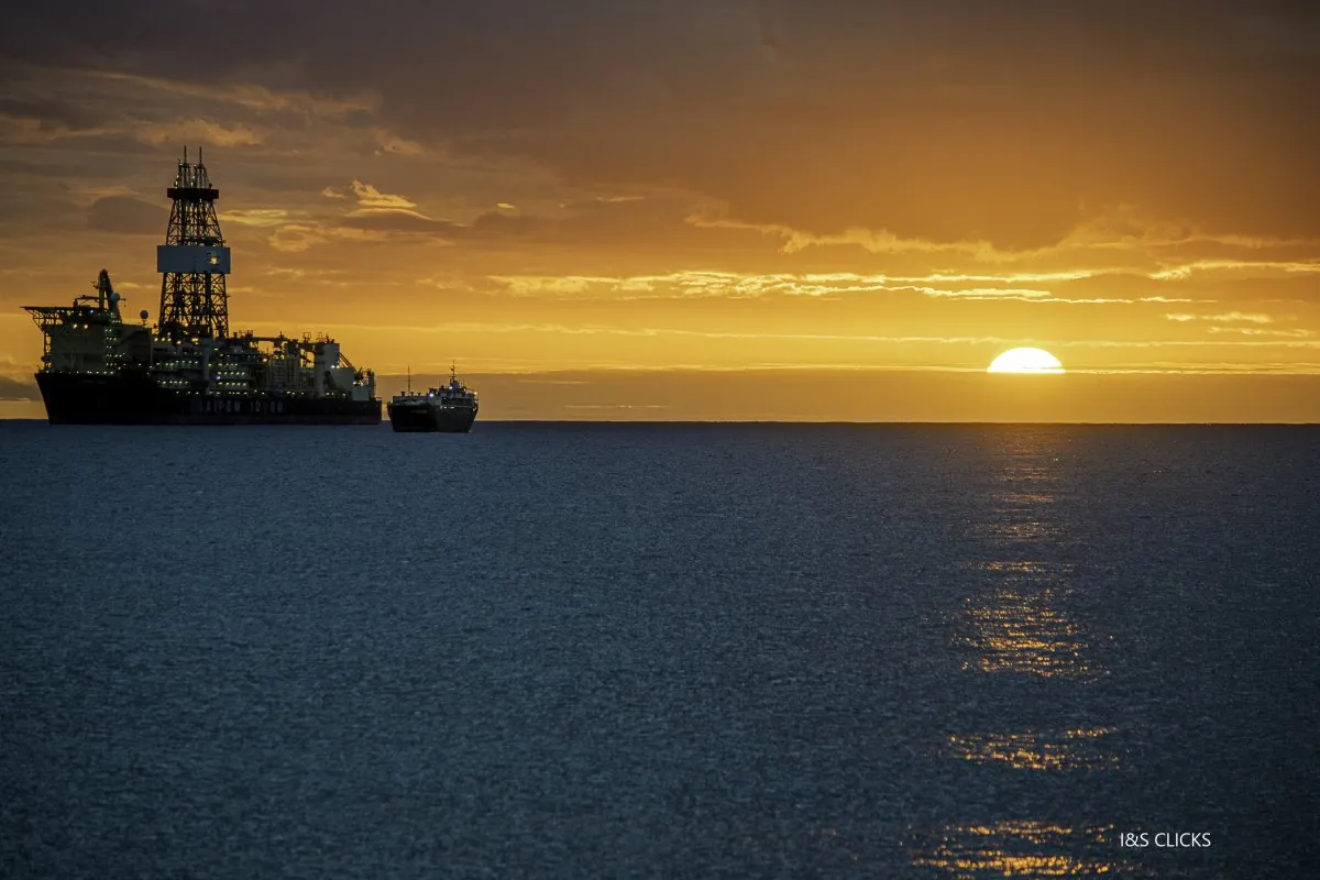 Large ship leaving Port Louis harbor at sunset near Bain des Dames in Mauritius