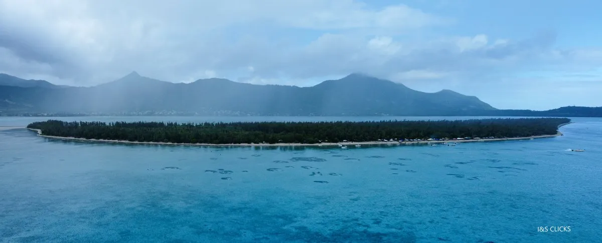 Aerial panoramic view of Ile aux Benitiers island with white sand beach and clear lagoon waters in Mauritius