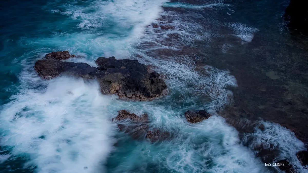 Aerial view of blurred waves and volcanic rocks at Gris Gris beach in Mauritius