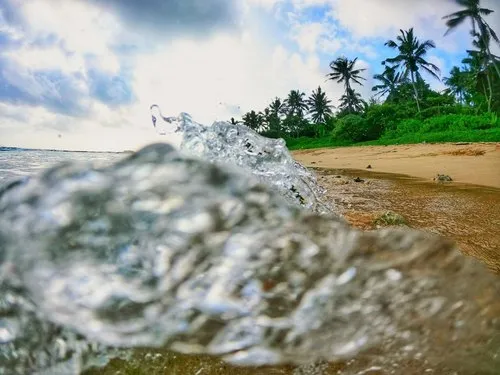 Close up of translucent waves reaching beach