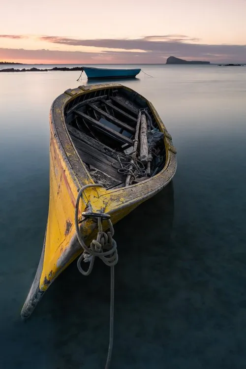Yellow pirogue in calm lagoon of Mauritius