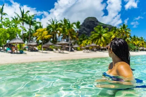Girl from lagoon looking at Le Paradis hotel