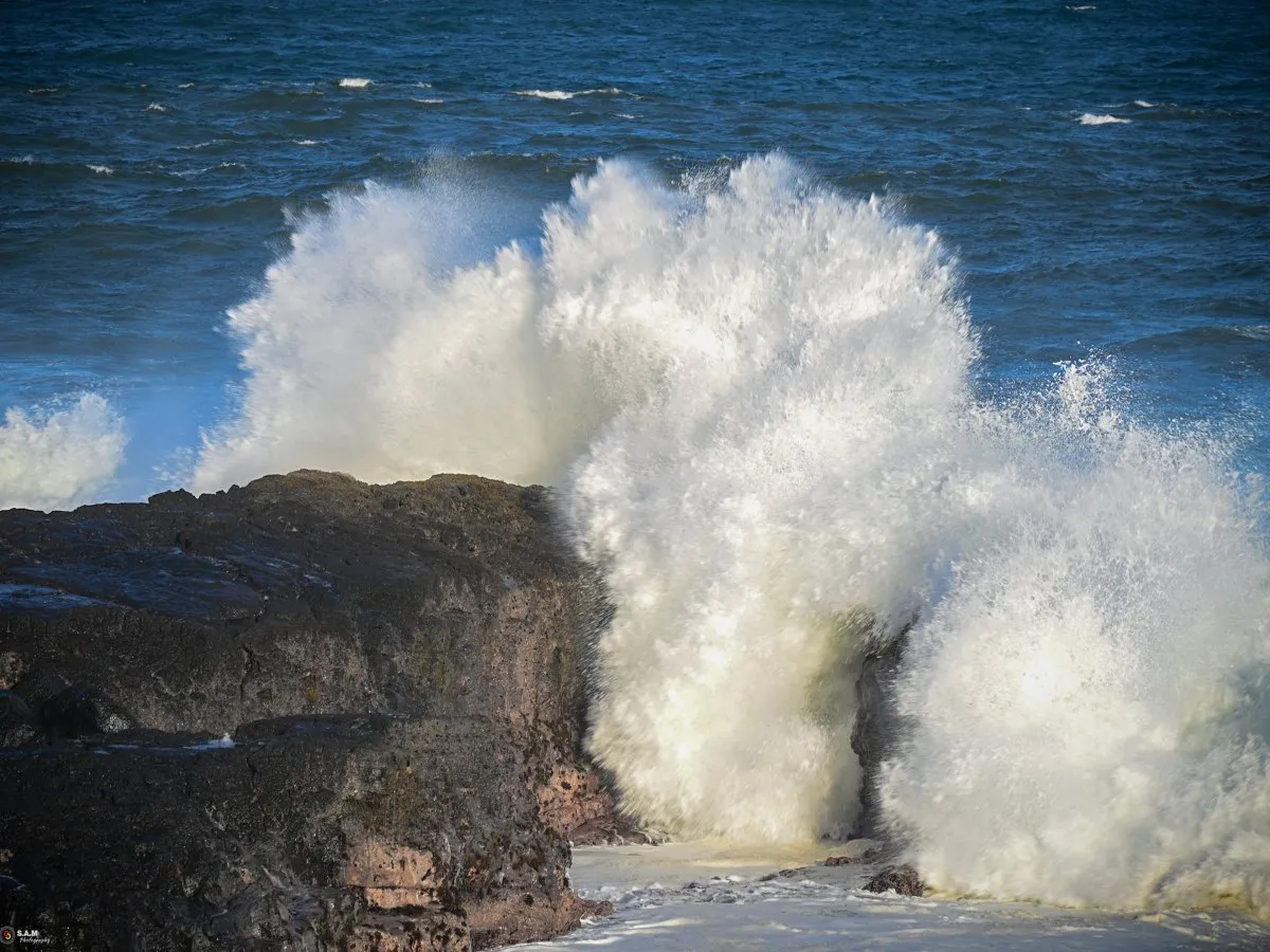 Powerful waves and rough sea crashing against dark coastal rocks at Gris Gris on the south coast.