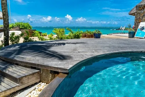 Wooden Decking next to turquoise hotel pool