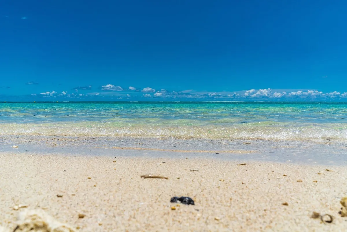 Cloudless blue sky over a pristine secret beach with shallow water in Mauritius