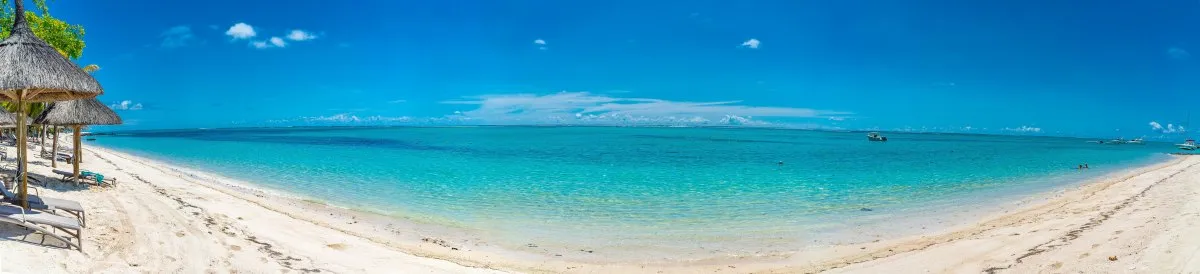 Panoramic view of Le Paradis Beach and turquoise lagoon in Mauritius under clear sky