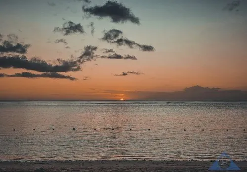 Half sun above sea during Sunset at Flic en Flac beach