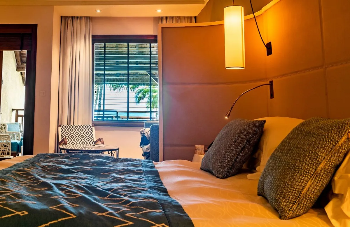 Elegant bedroom interior at Constance Belle-Mare hotel in Mauritius with a cozy and stylish design