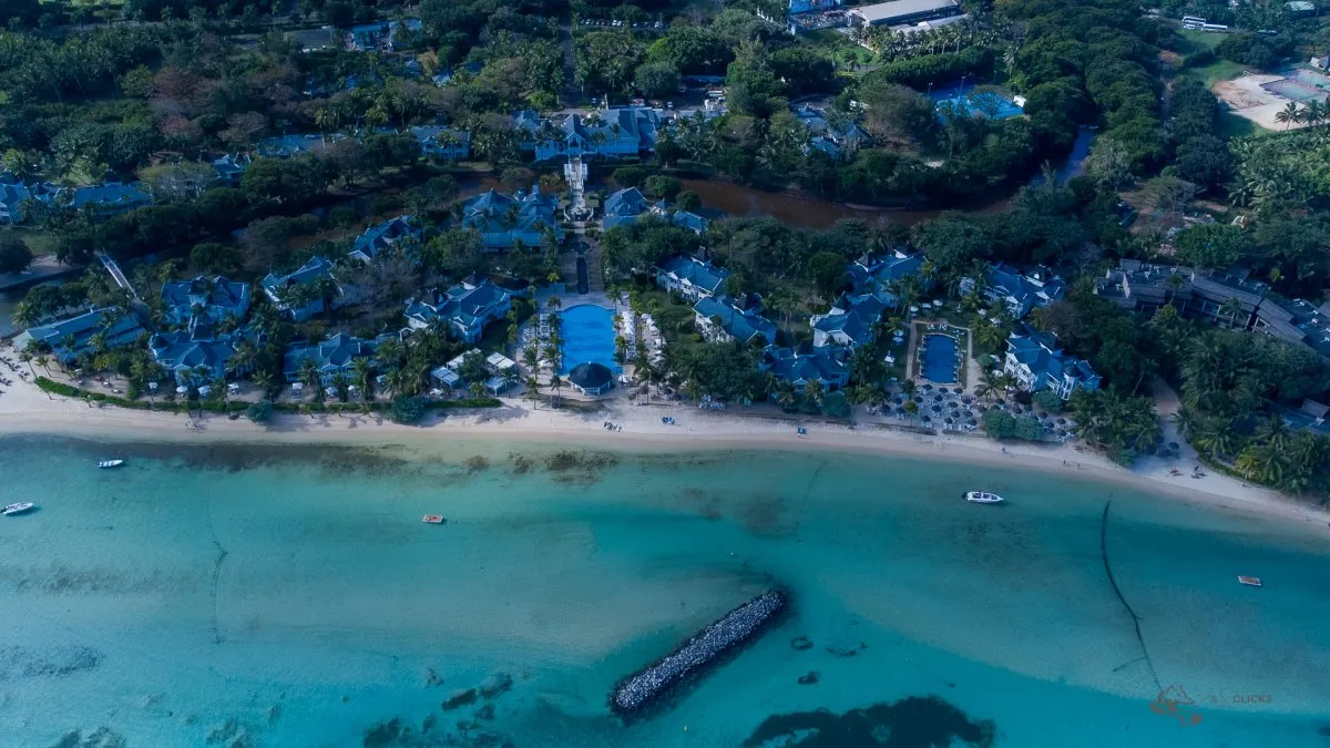 Aerial view of Heritage Le Telfair Golf & Wellness Resort with beach and pools in Mauritius