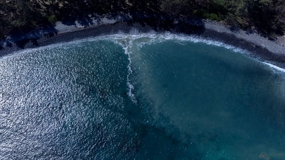 Aerial shot of Rivière des Galets beach and Ilot Sancho islet in Mauritius with waves and coastal scenery