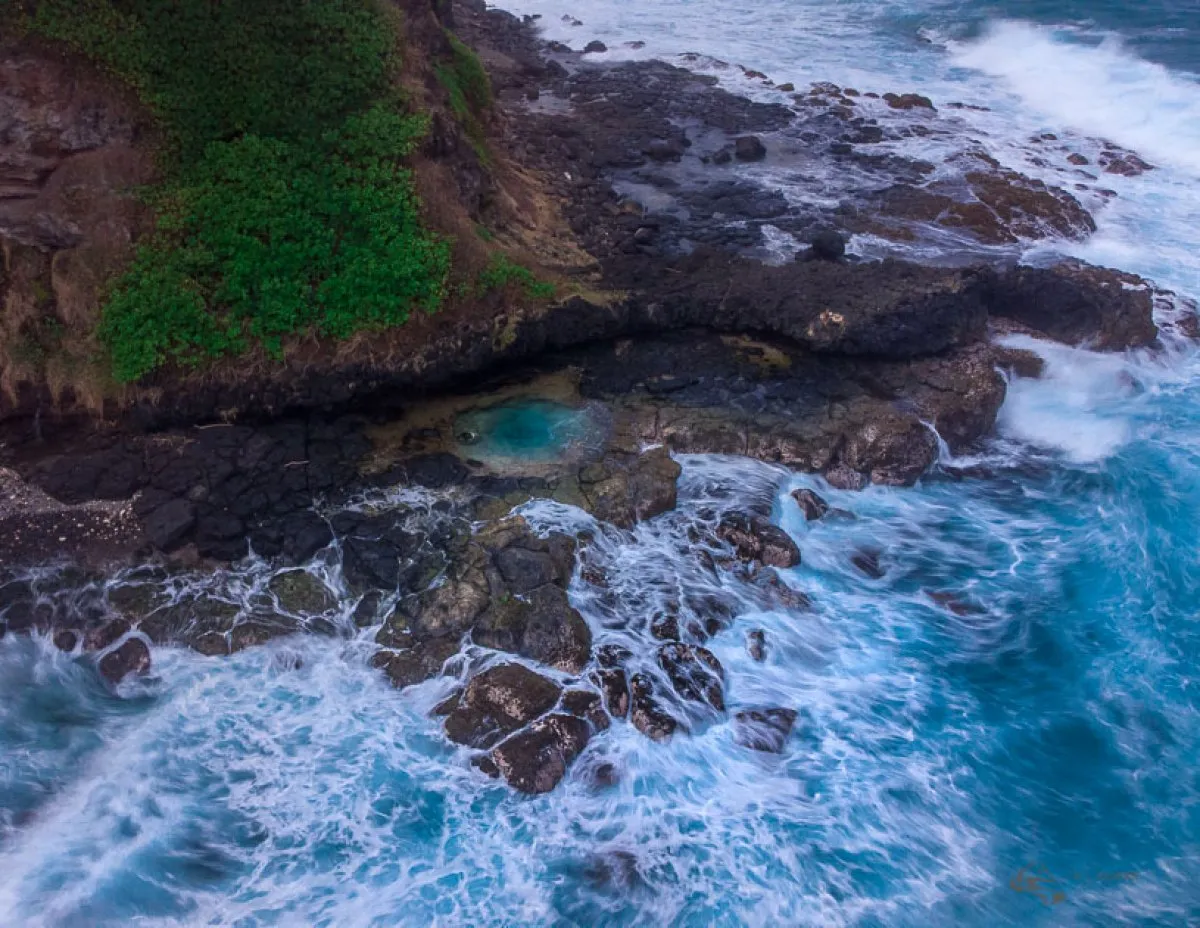 Aerial view of La Roche Qui Pleure natural pool with turquoise waters and tropical vegetation in Mauritius