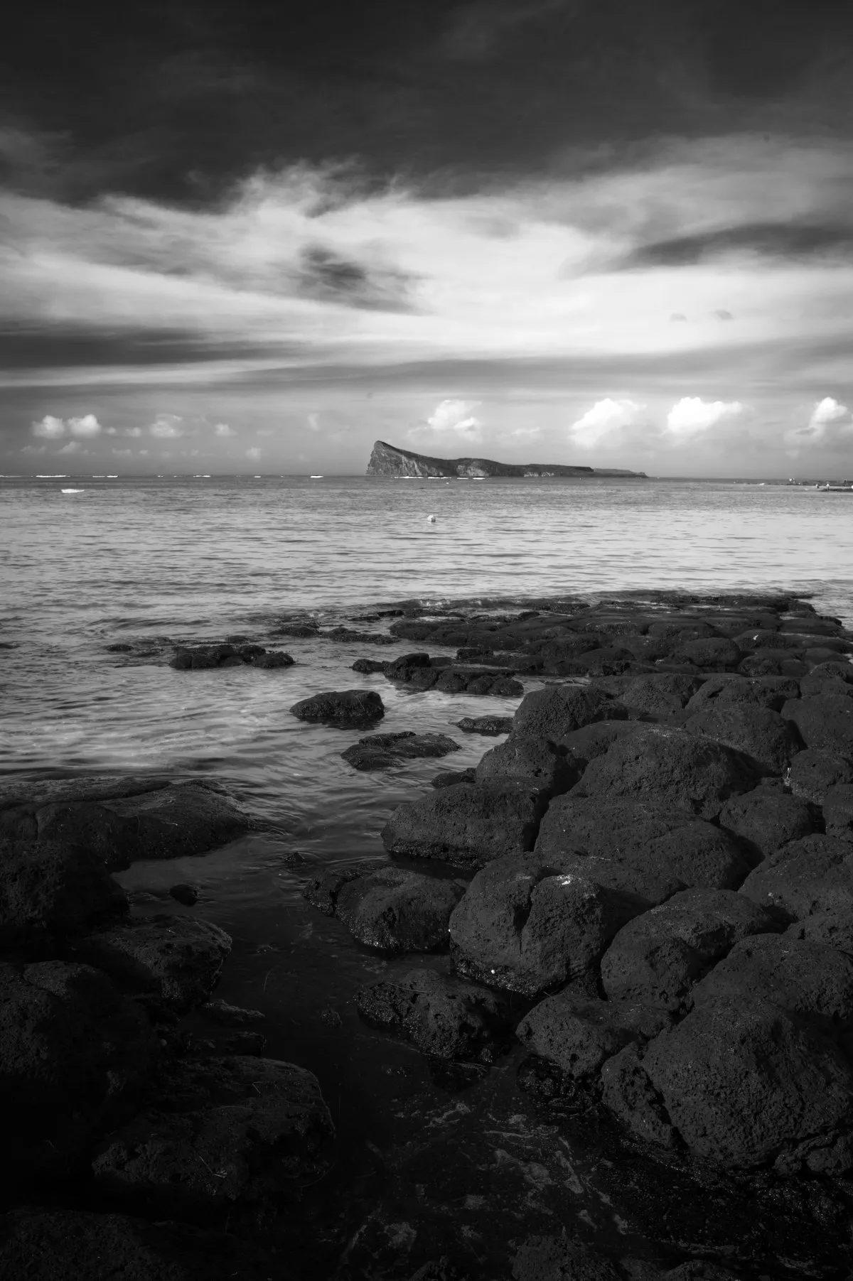 Scenic black and white view of Coin de Mire rock formation off Bain Boeuf beach in northern Mauritius