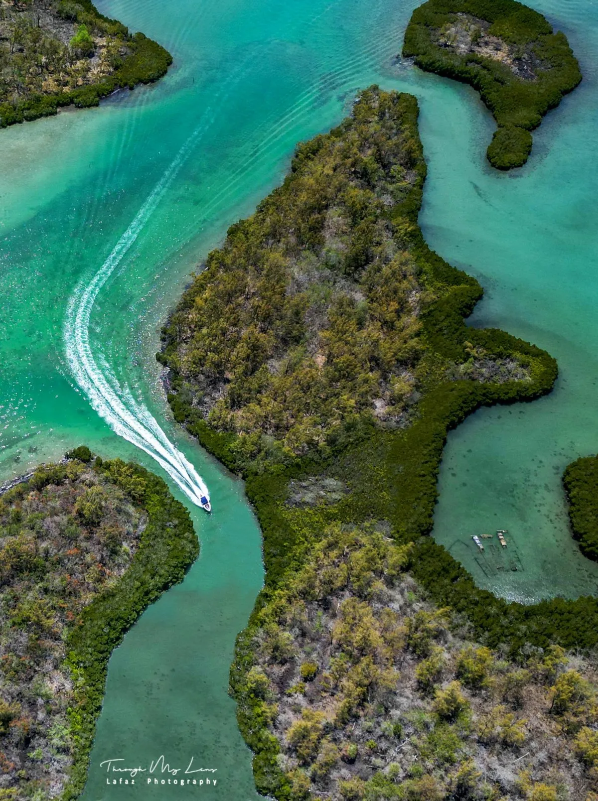 Aerial view of Ile Aux Cerf's turquoise lagoon and lush greenery in Mauritius, captured by drone.