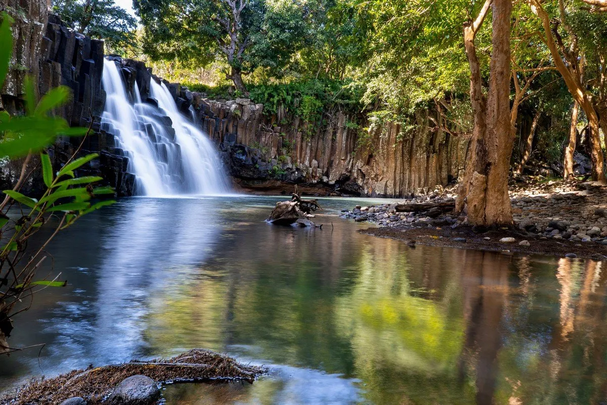 Rochester Falls waterfall with unique rectangular rock formations in Mauritius surrounded by lush greenery