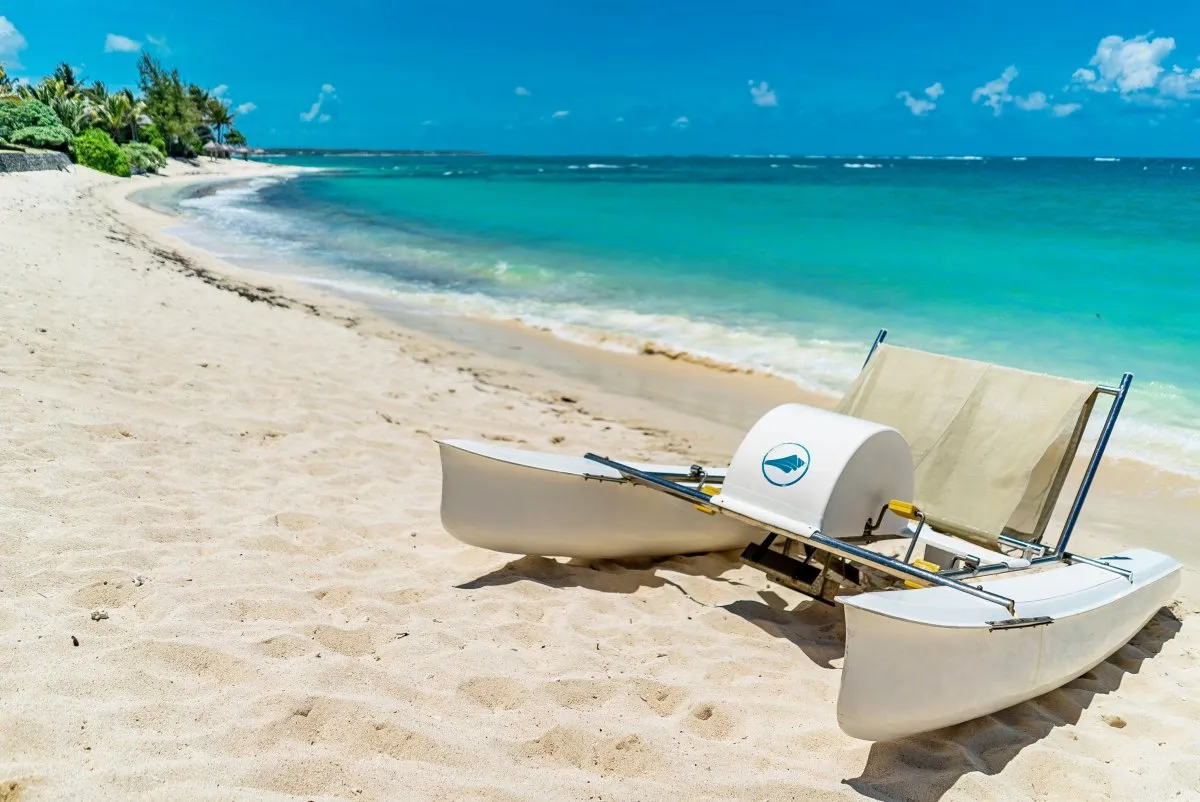 White pedalo on turquoise beach at Constance Belle-Mare Plage in Mauritius