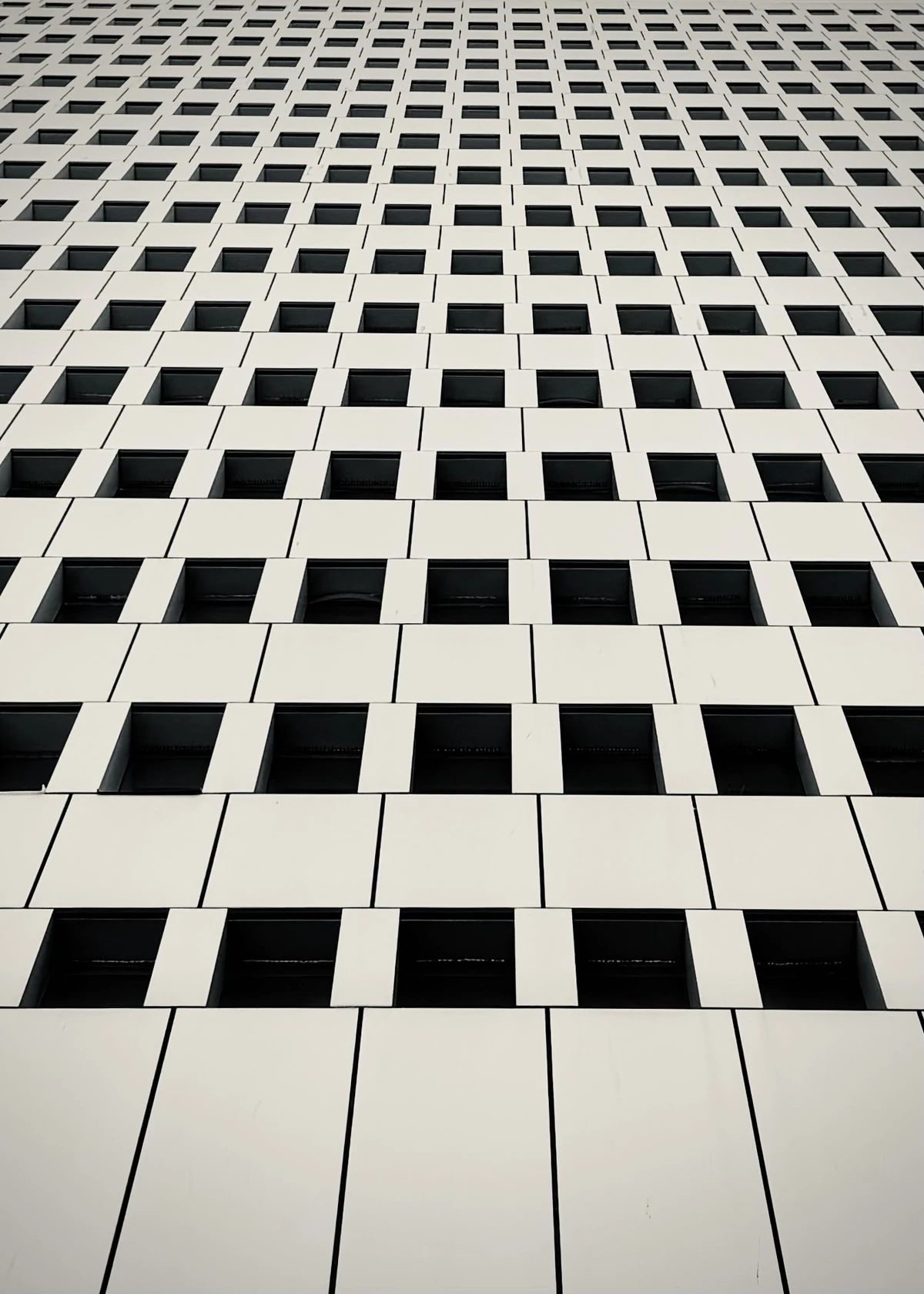 Abstract view of the Paille en Queue Building, also known as the Air Mauritius Building, with repeating geometric windows in Port Louis, Mauritius.