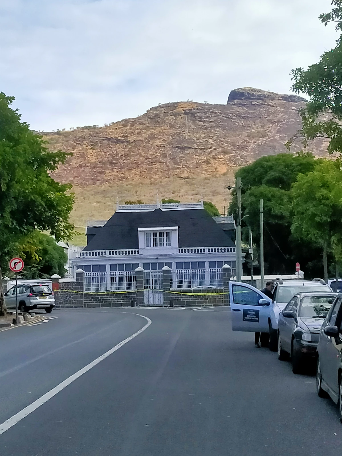 Colonial-style house on D’Estaing Street near Champ de Mars in Port Louis, with Signal Mountain rising in the background.