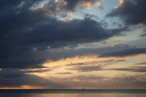 Dramatic Clouds Over Trou d’Eau Douce at Sunset