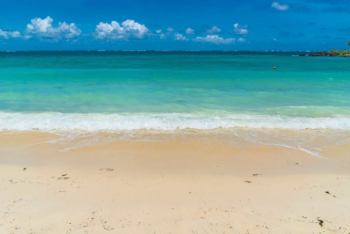 Turquoise sea and white sandy beach at Constance Belle Mare hotel in Mauritius under clear sky