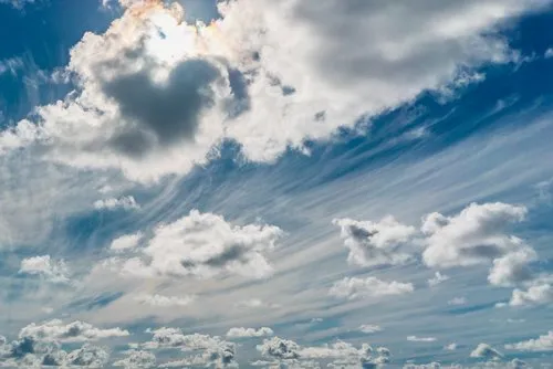 Background of white beautiful windy clouds on blue sky