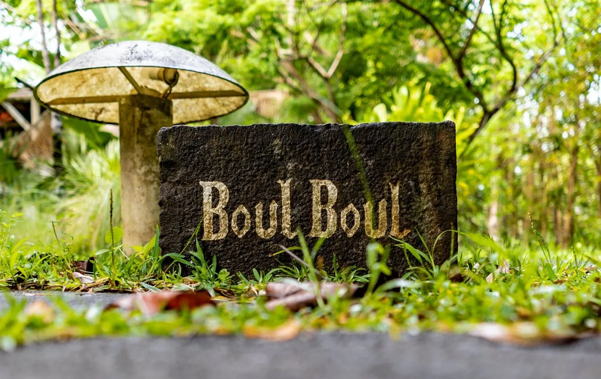 Engraved natural rock with L'Exil lodges name in a forest setting in Mauritius