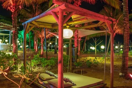 Outdoor canopy wooden relaxing bed at night