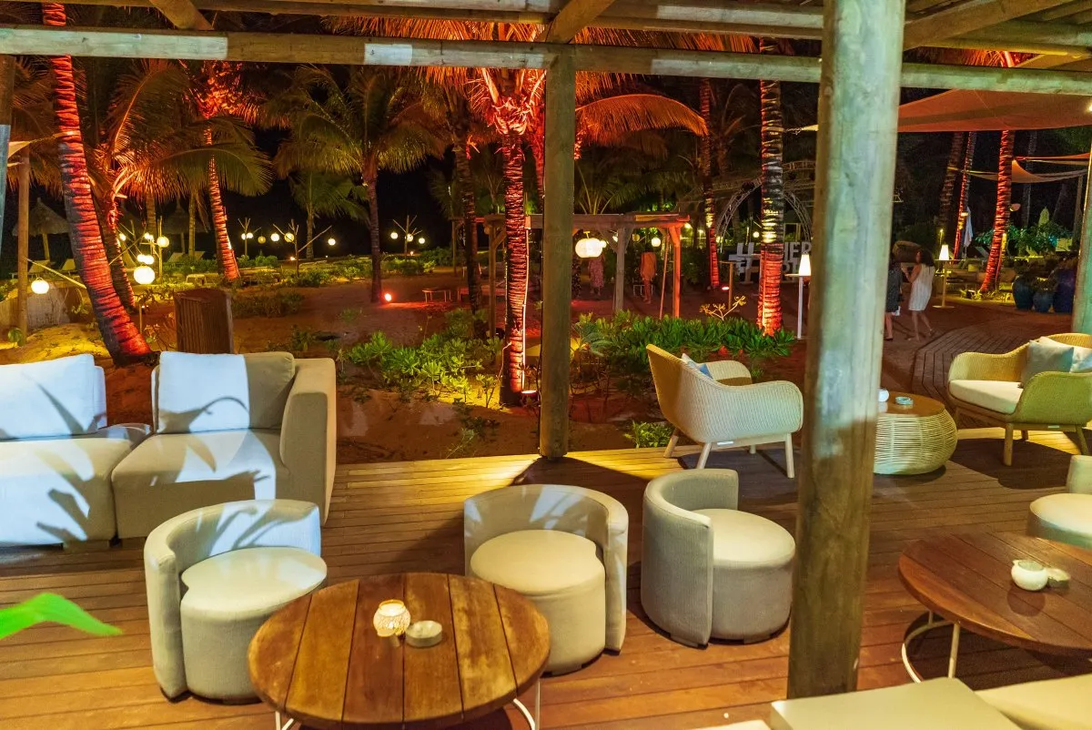 Cozy lounge corner with illuminated garden plants at Heritage C Beach Club in Mauritius at night