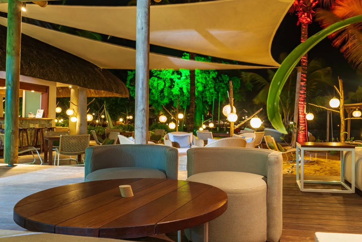 Cozy wooden table and seating corner at Heritage Beach Club in Mauritius