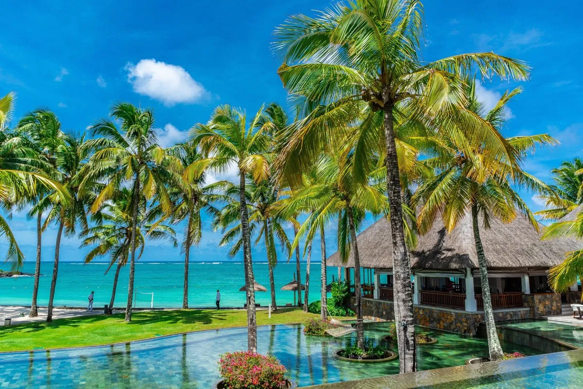 Lagoon, pool, and coconut trees at Constance Belle-Mare Plage Hotel in Mauritius