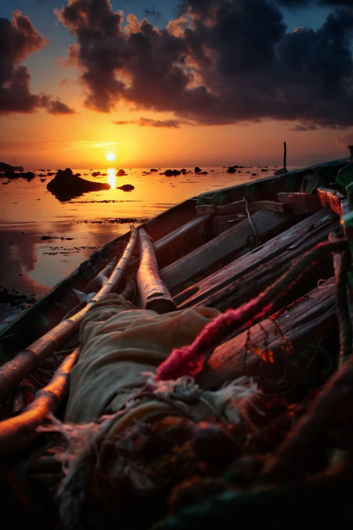 Old fisherman boat at sunrise on the beach of Rivière des Créoles in Mauritius