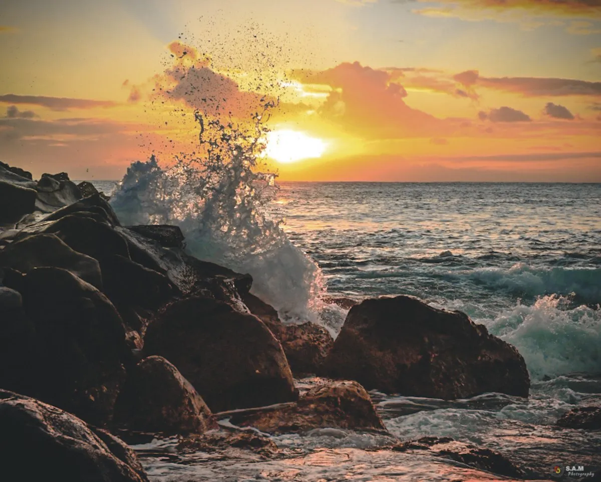 Waves crashing against rocks at Albion bay during sunset in Mauritius