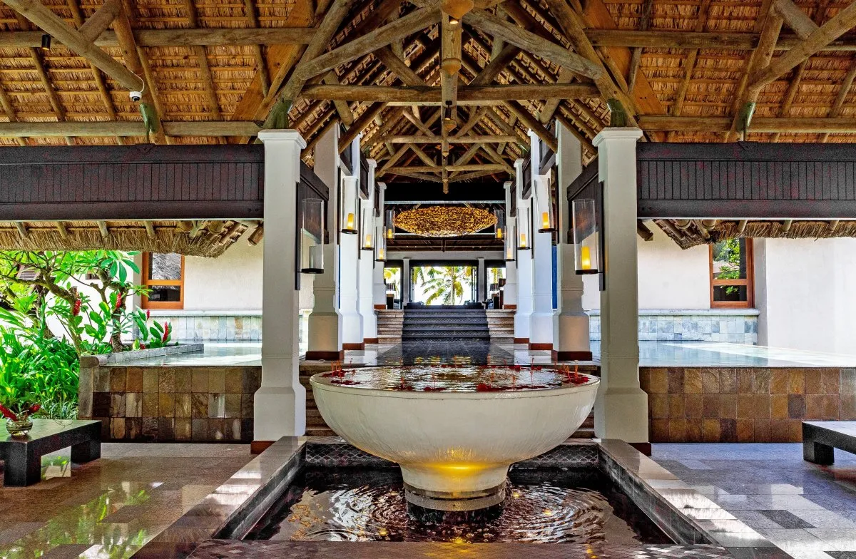 Entrance of a 5 star hotel with a fountain overflowing into a pond in Mauritius