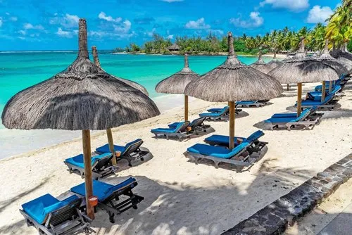 Beach, deckchairs & thatched umbrellas at Constance hotel beach