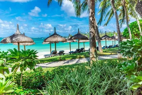 Constance hotel turquoise lagoon view under thatched umbrella