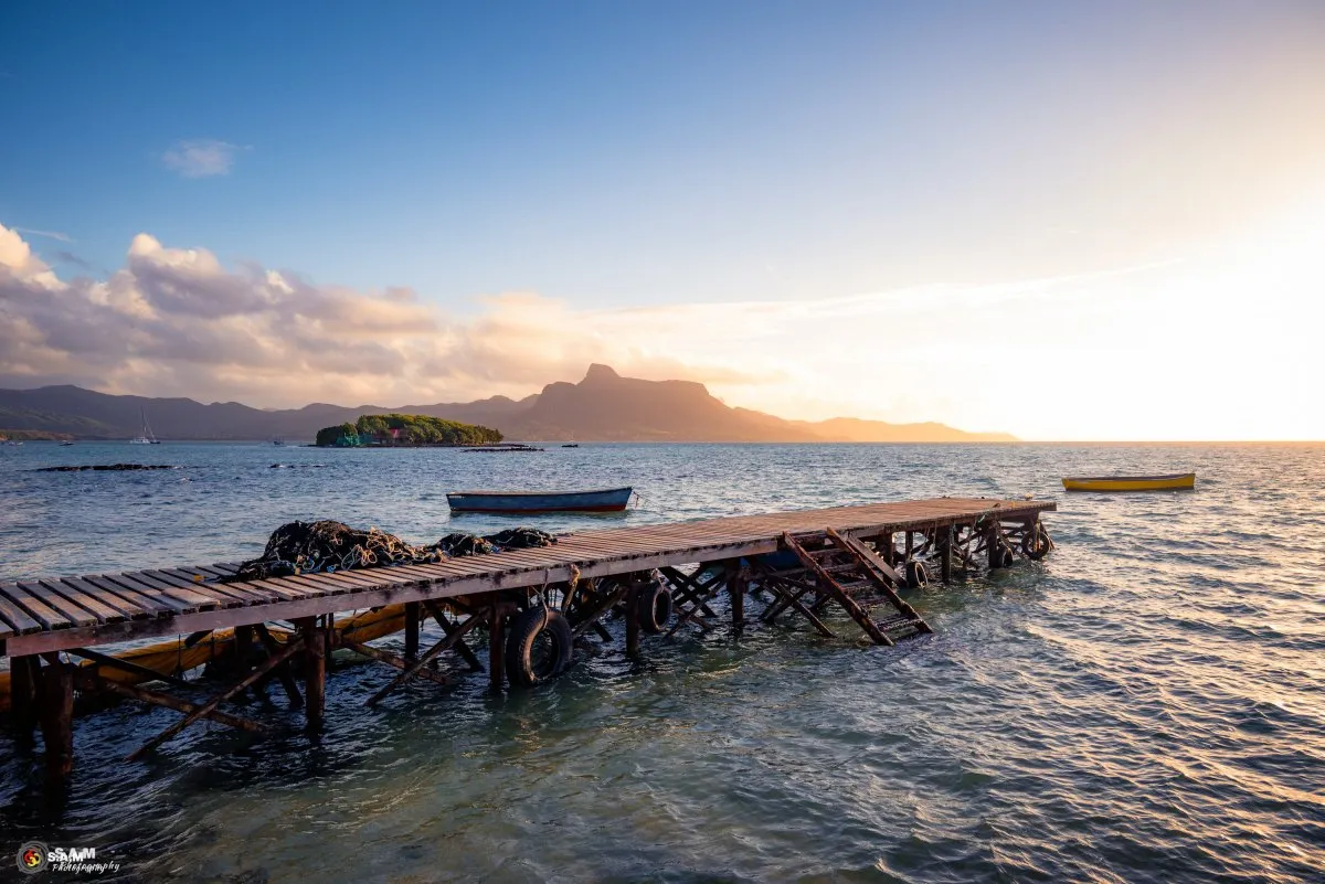 Fishing net on Mahebourg jetty with fishermen boats and mountains in the background in Mauritius
