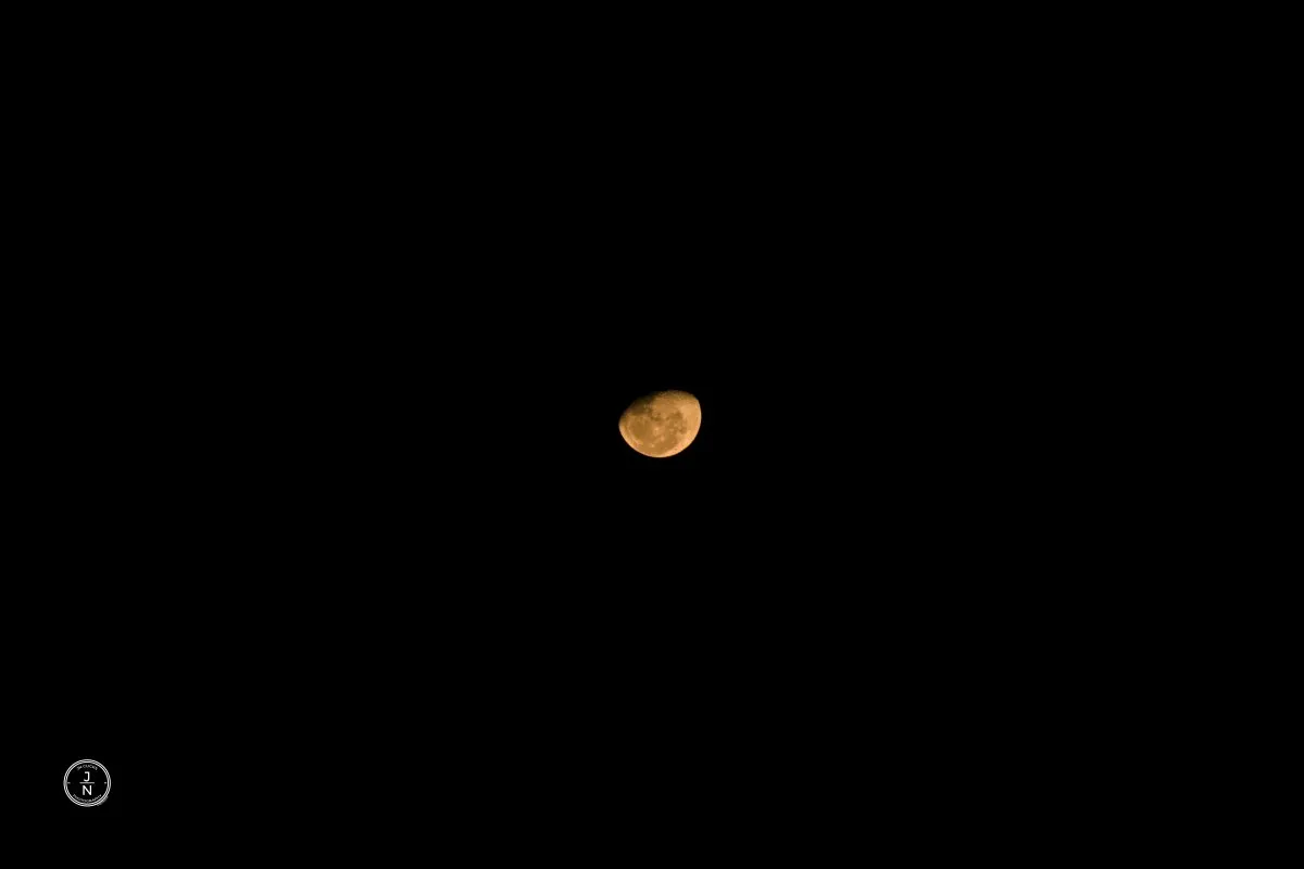 Yellow moon glowing in the clear night sky over Mauritius