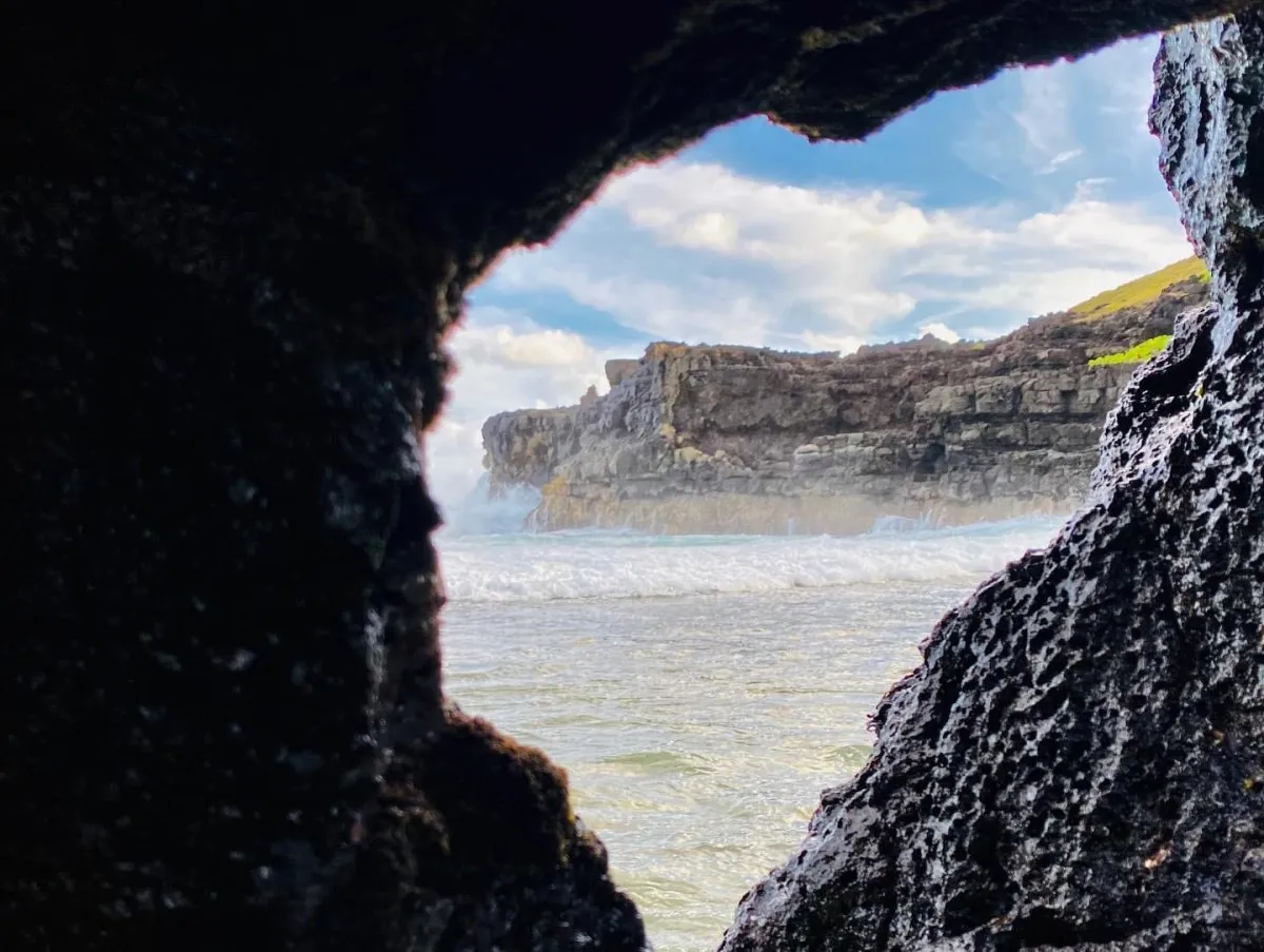 View of window cave with waves at La Roche Qui Pleure cliff in Mauritius