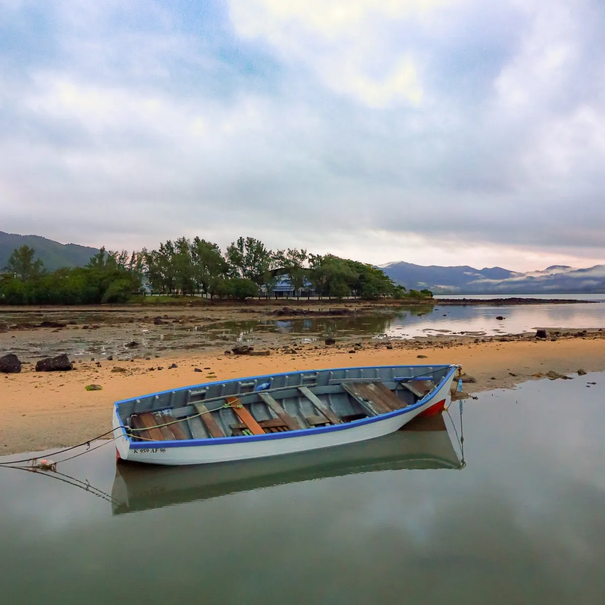 Fishing boat leaning at low tide near Mahebourg coast in Mauritius