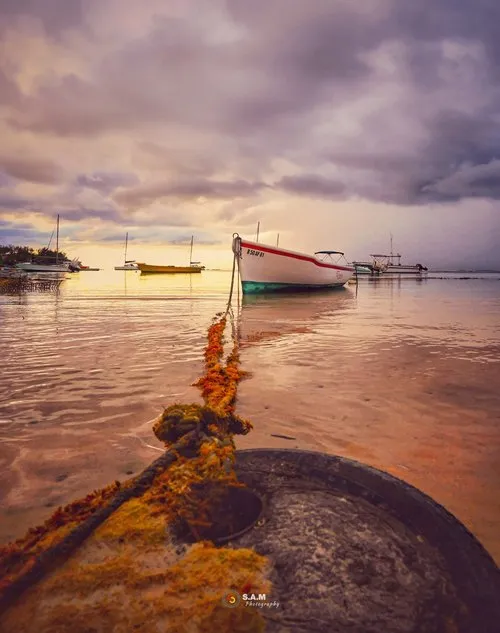 Boat in the lagoon tied up with long rope