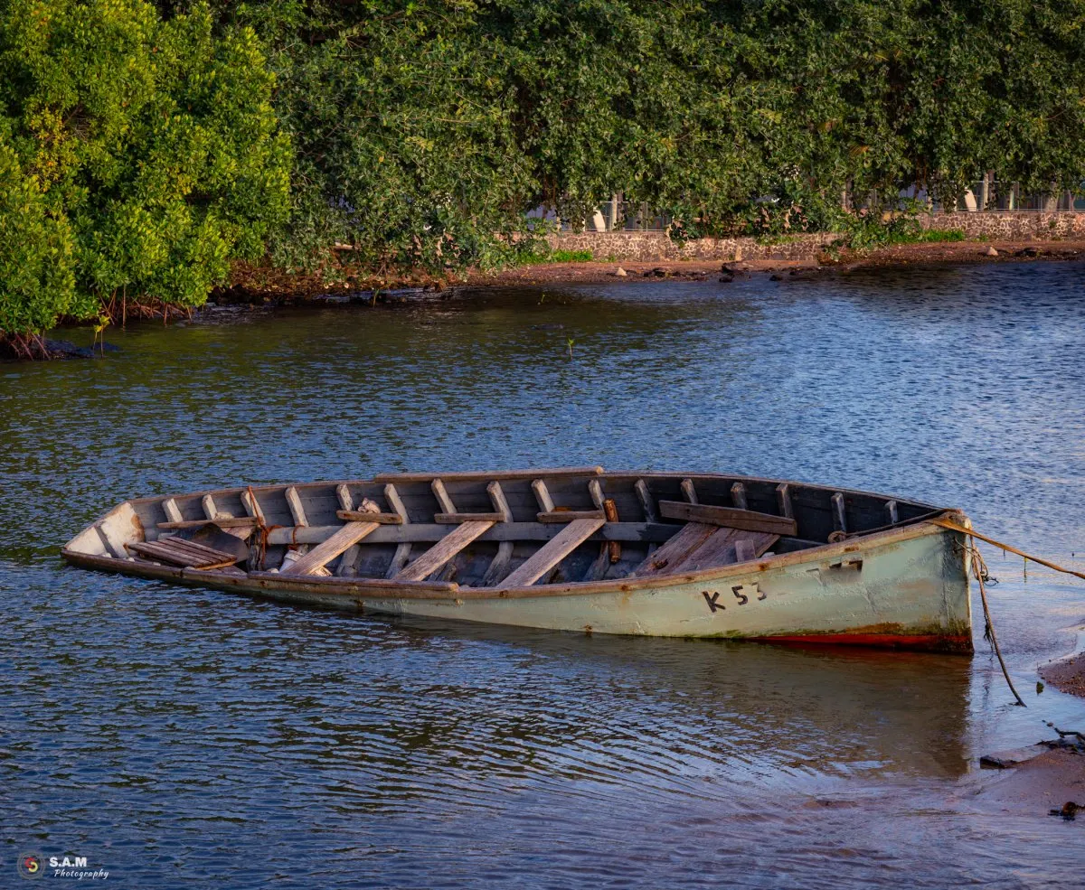 Old sunken fisherman pirogue in the lagoon near Mahebourg coast, Mauritius