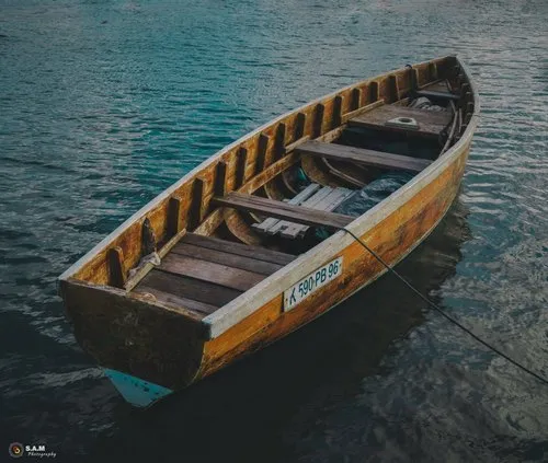 Unpainted wooden boat at sea